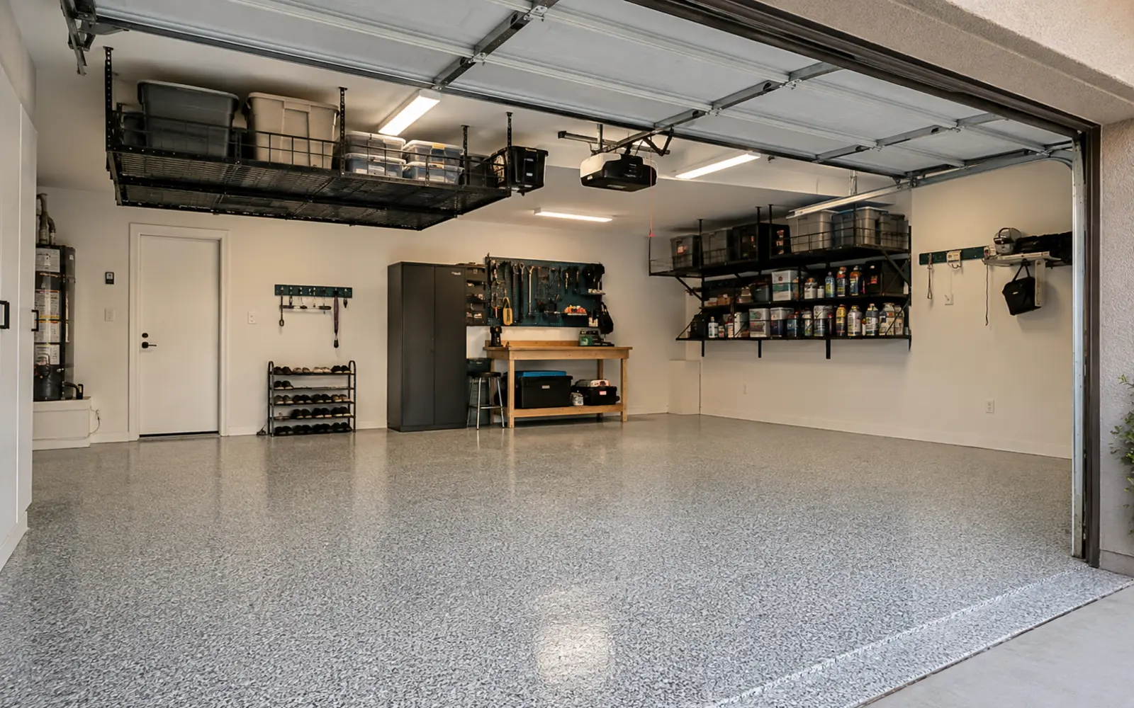 Organized garage with an epoxy floor and overhead storage